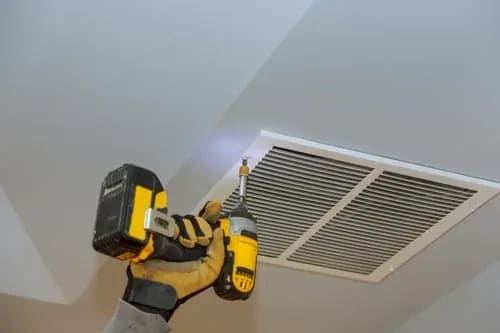 EM Mechanical NY LLC technician servicing a heating and cooling system in Staten Island