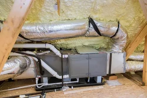 New central air handler and ductwork installed in a residential attic