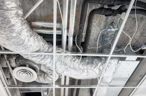 Insulated HVAC ductwork and ceiling supply vent in a residential building
