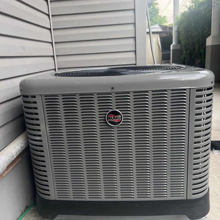 Rheem condenser installed on a pad in a narrow side yard