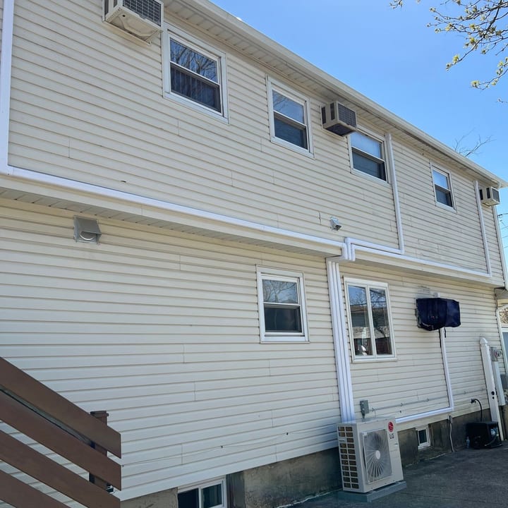 Line-set covers running up the exterior wall of a multi-family building