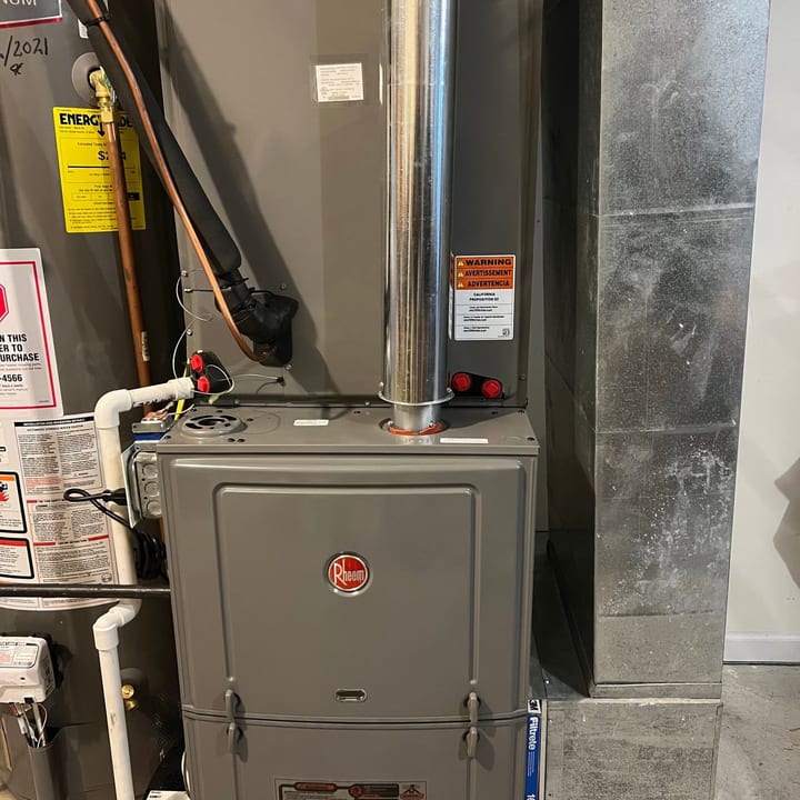 Rheem furnace installed in a basement beside the water heater