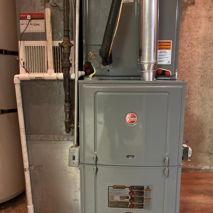 Rheem gas furnace installed in a basement mechanical room