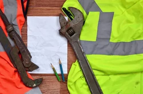 HVAC service technician tools and safety gear laid out for a maintenance visit